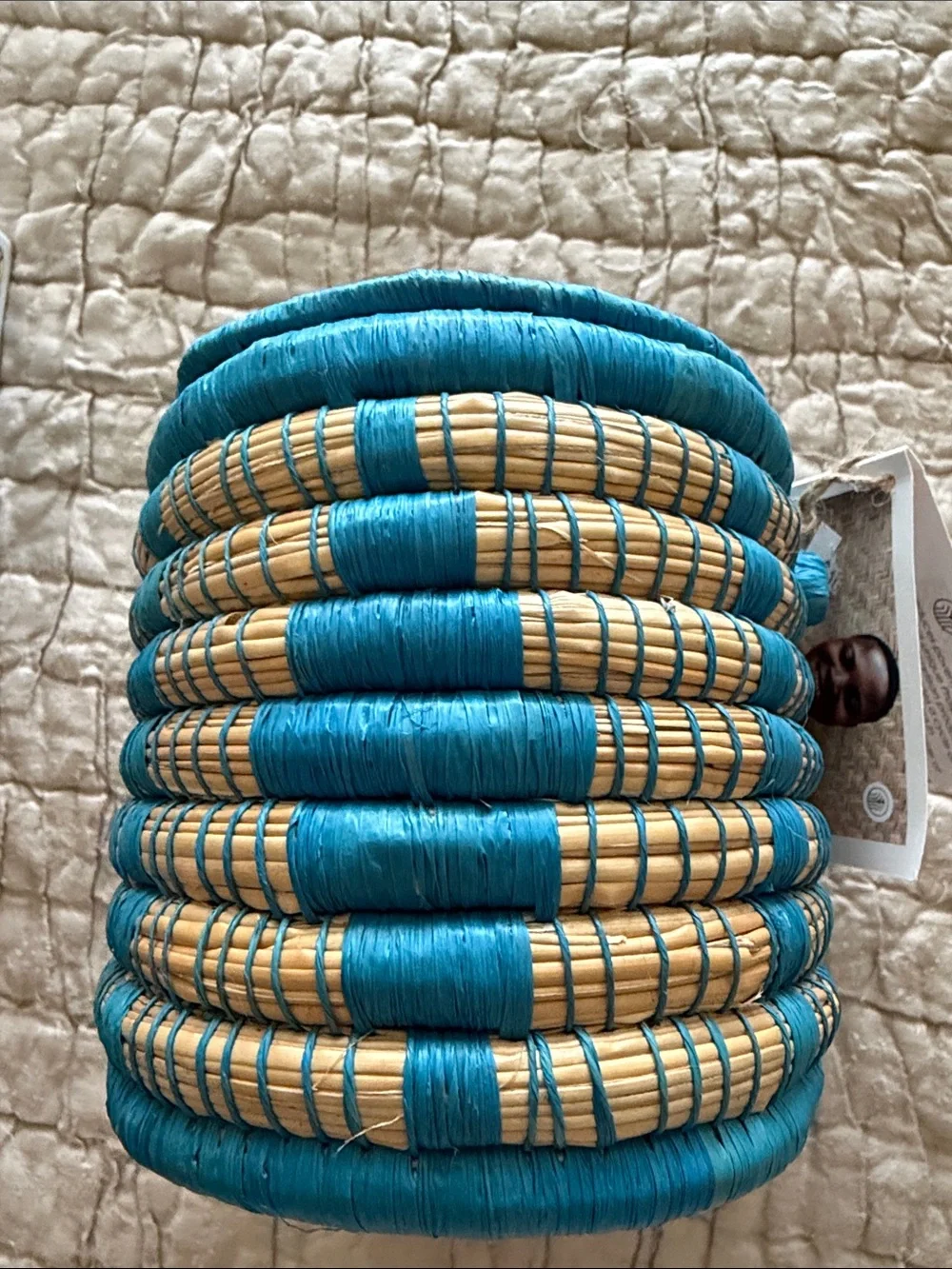 Handmade turquoise and tan coveted basket from Uganda clasp in the front
